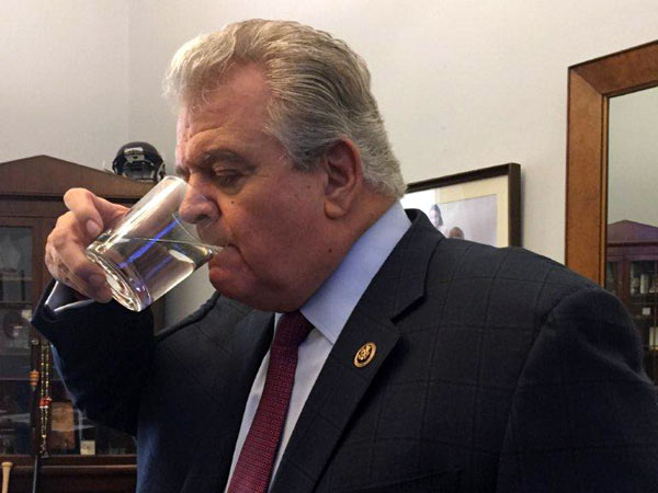 U.S. Rep. Bob Brady sips from the glass used by the pope.