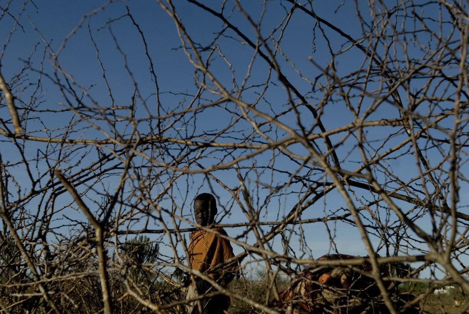 A youth Karamojong villager walks inside his transitorial compound near the town of Moroto, April 7, 2008. Cattle rustling is a common occurrence in the region and it is perpetrated among the villagers themselves. Walter ASTRADA