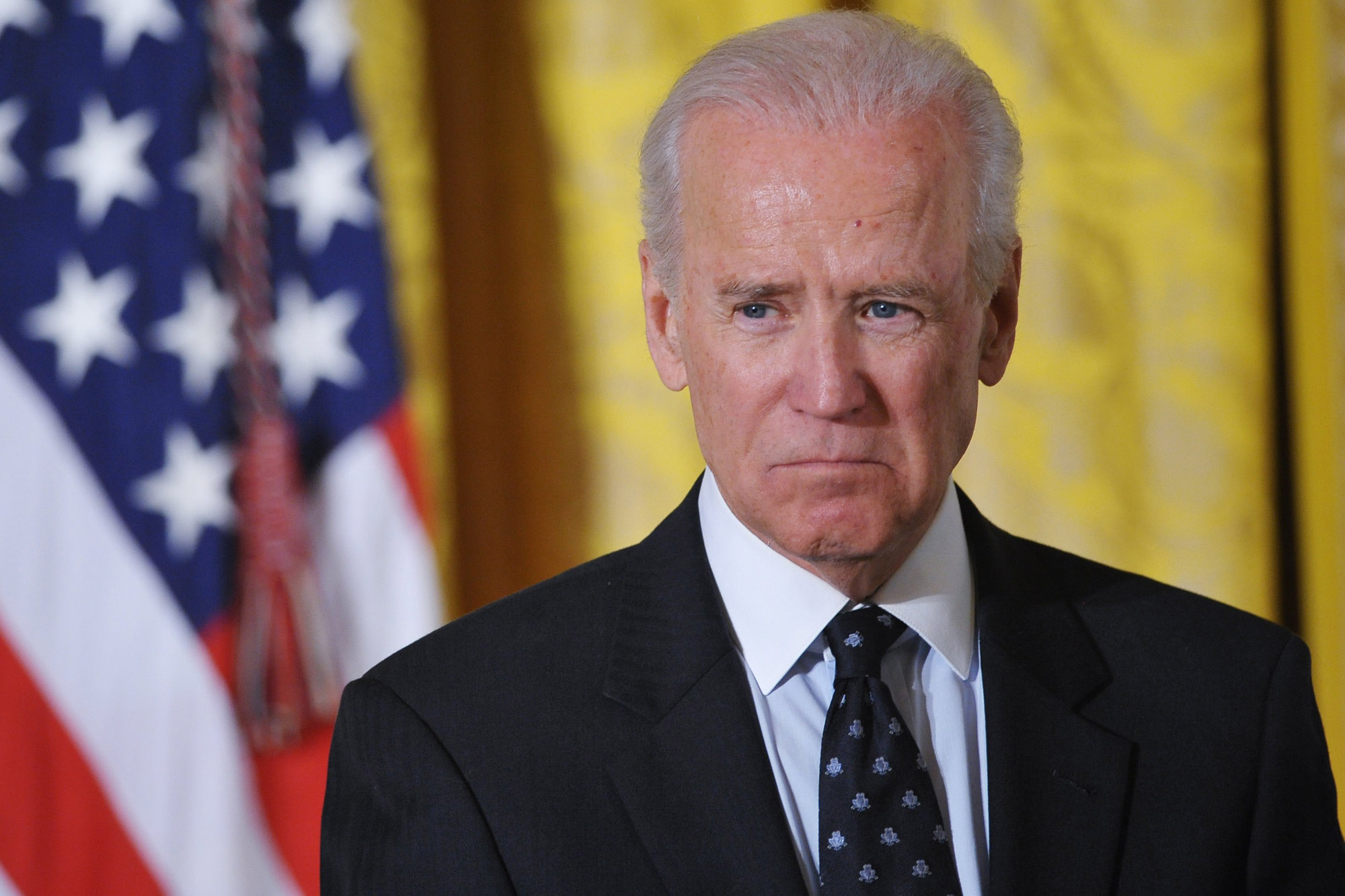 US Vice President Joe Biden watches as US President Barack Obama speaks during an event for the Council on Women and Girls in the East Room of the White House on January 22, 2014 in Washington, DC. AFP PHOTO/Mandel NGANMANDEL NGAN/AFP/Getty Images
