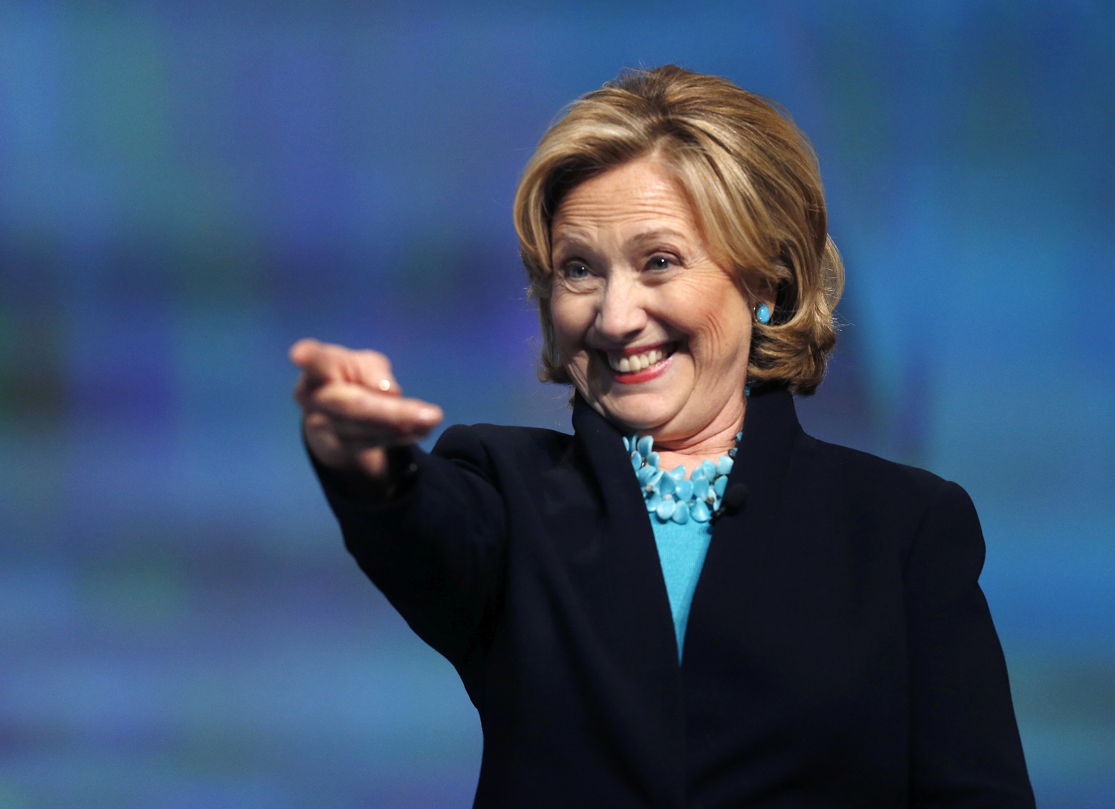 Former Secretary of State Hillary Rodham Clinton reacts as she is introduced to speak at the Massachusetts Conference for Women in Boston, Thursday, Dec. 4, 2014. (AP Photo/Elise Amendola)
